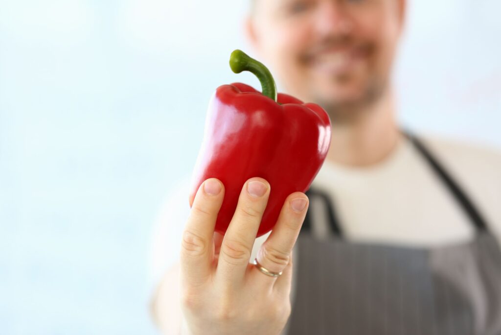 chef holds bell pepper